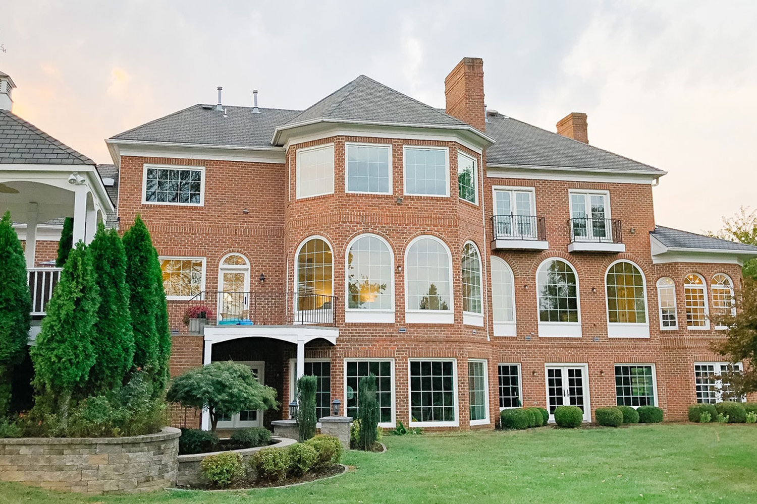 Exterior of Arched Manor with black Renewal by Andersen windows