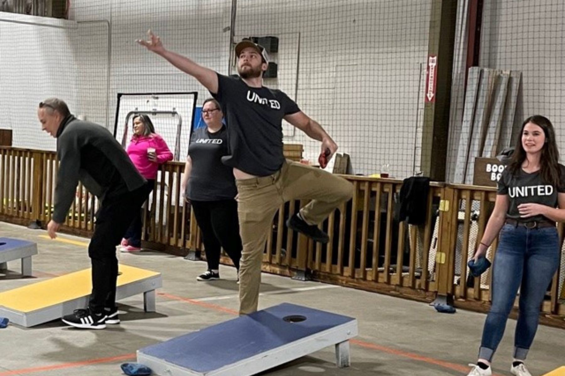 Group of RbA employees playing corn hole toss. 