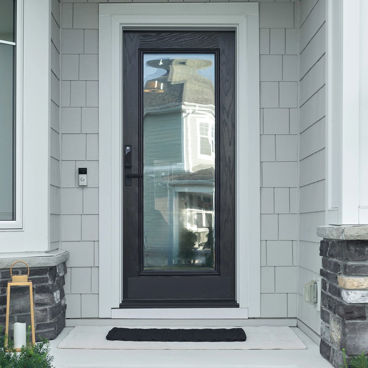 A single panel Ensemble entry door. The door is black and has full-light glass. It has white trim.