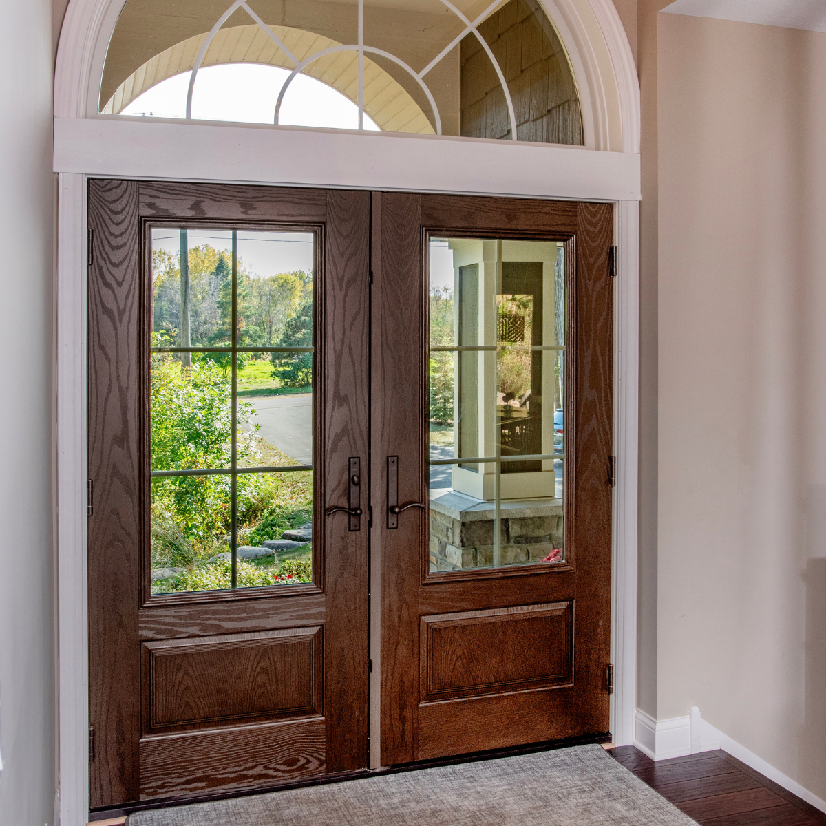 An ensemble entry double door form the interior. It is wood finish with black hardware.