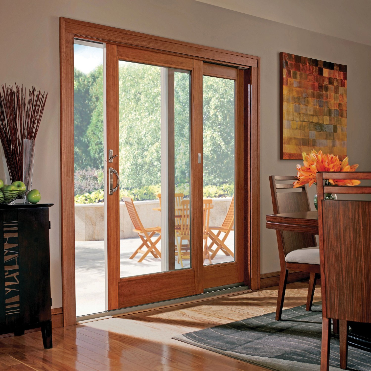 A set of sliding patio doors in a kitchen. The doors have an oak finish.