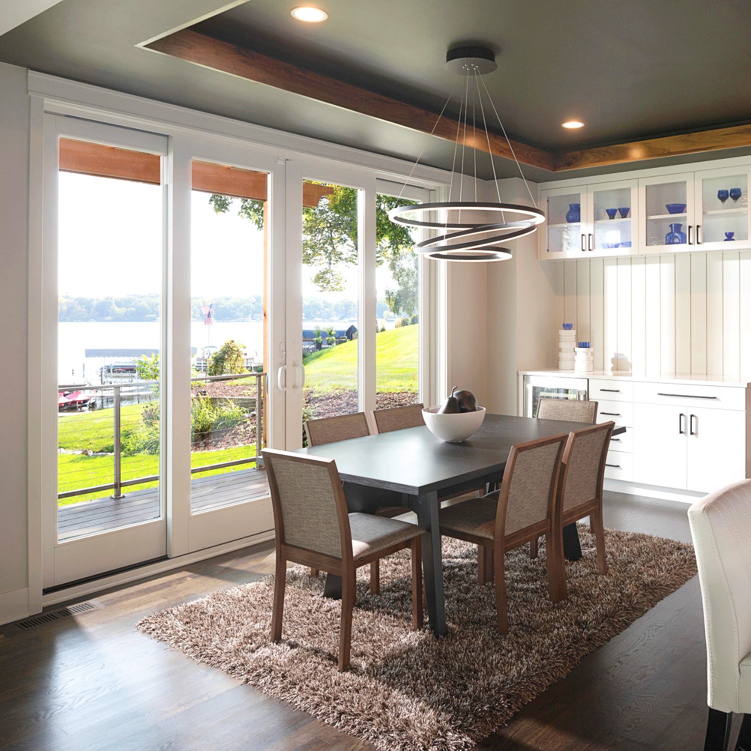 White sliding glass doors in a dining room at a lake house. 