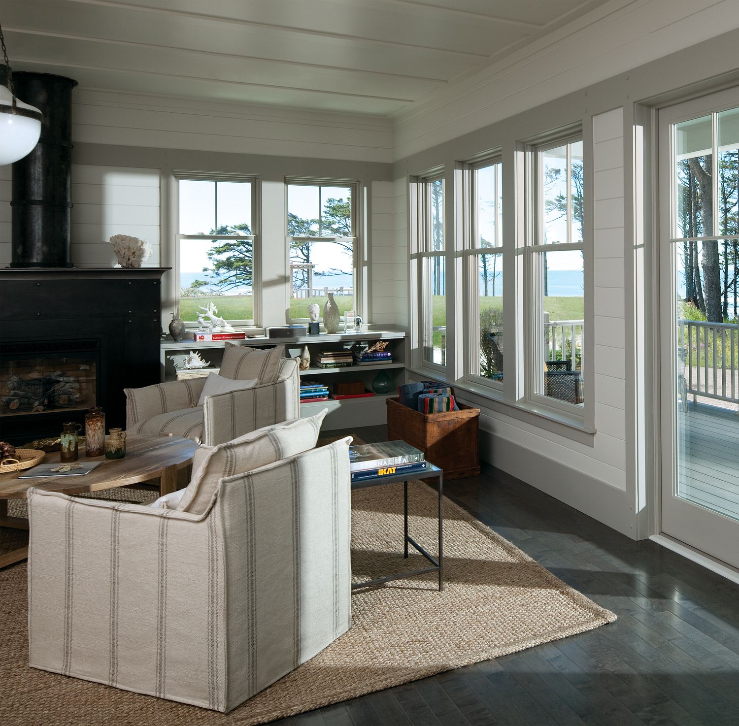 A living room view of a east coast back yard and waterfront.