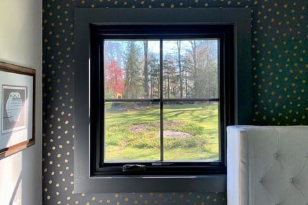 John's bedroom features neat square windows with equal lite grilles.