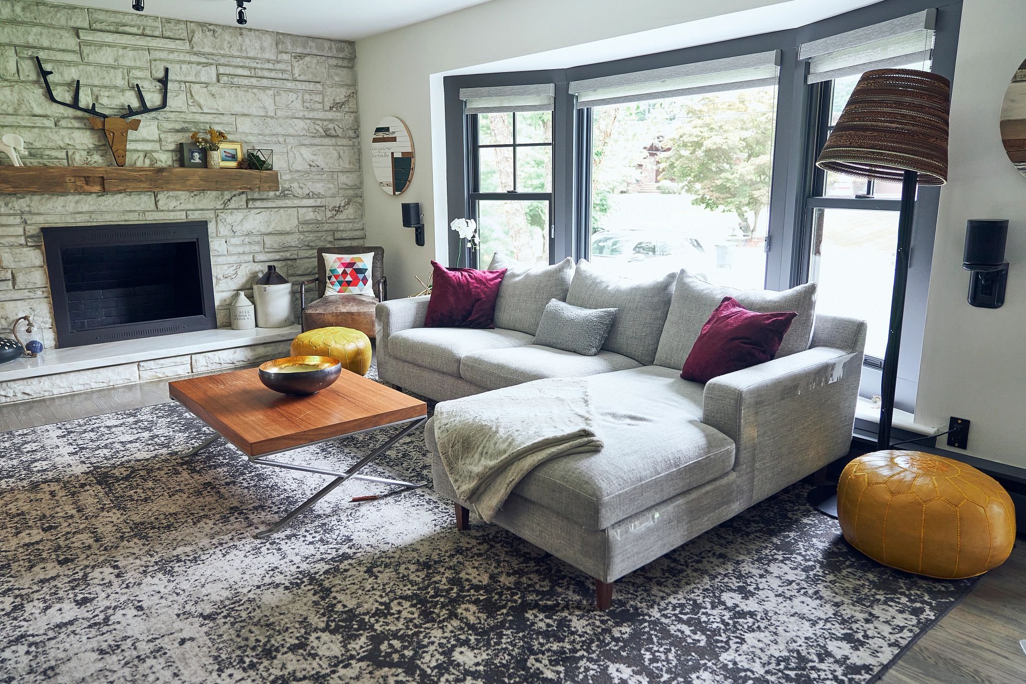 John's bay window inside his living room. He also has a large rug.