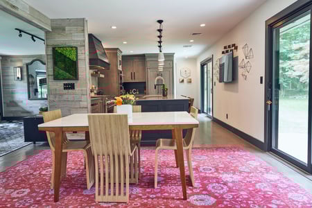 John's living and dining and kitchen space. There is another large rug.